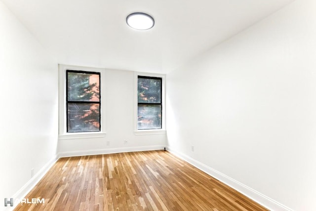 unfurnished room with light wood-style floors and baseboards