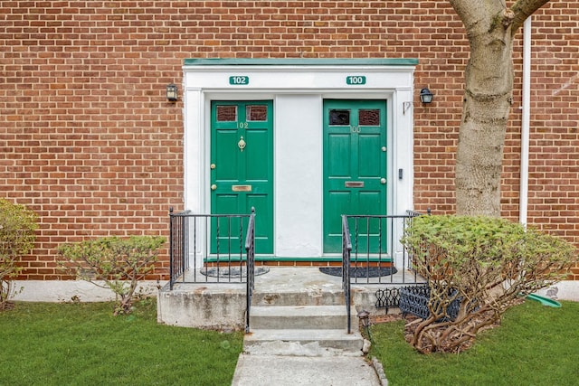 property entrance featuring brick siding