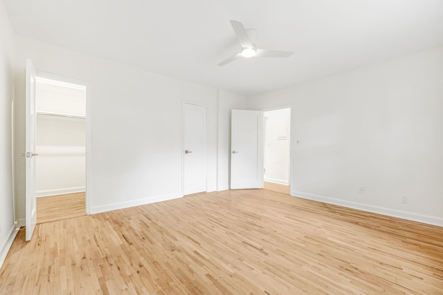 unfurnished bedroom featuring light wood-type flooring, baseboards, and a ceiling fan