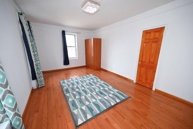 unfurnished room with baseboards and wood finished floors