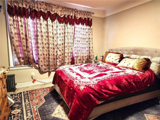 carpeted bedroom featuring radiator heating unit