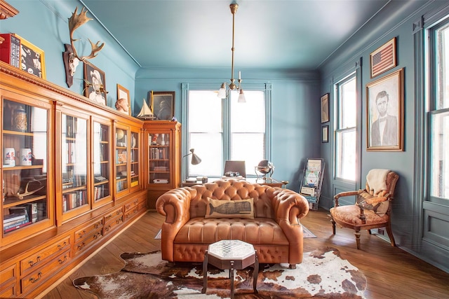 sitting room featuring hardwood / wood-style floors and ornamental molding