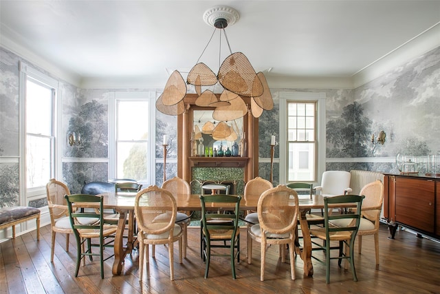 dining space with ornamental molding, plenty of natural light, hardwood / wood-style floors, and wallpapered walls