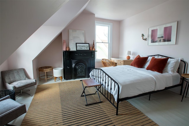 bedroom featuring a fireplace and vaulted ceiling