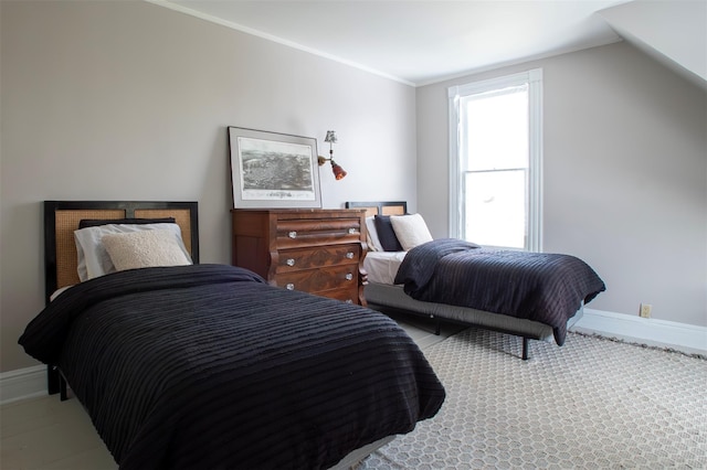 bedroom with baseboards and ornamental molding