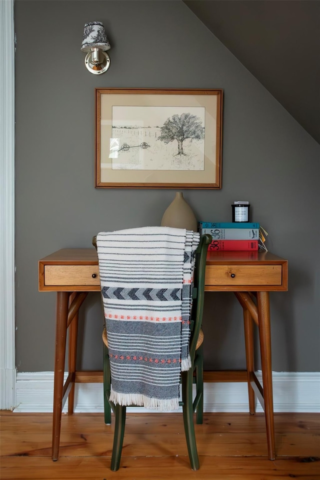 interior space with baseboards and wood finished floors