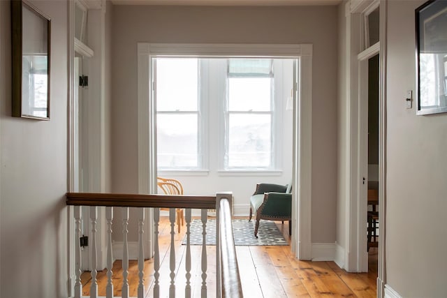 entryway with light wood finished floors and baseboards