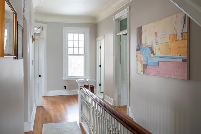 corridor featuring baseboards and wood finished floors