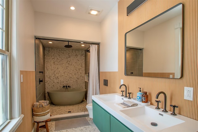 full bath featuring a freestanding tub, double vanity, a shower with curtain, and a sink