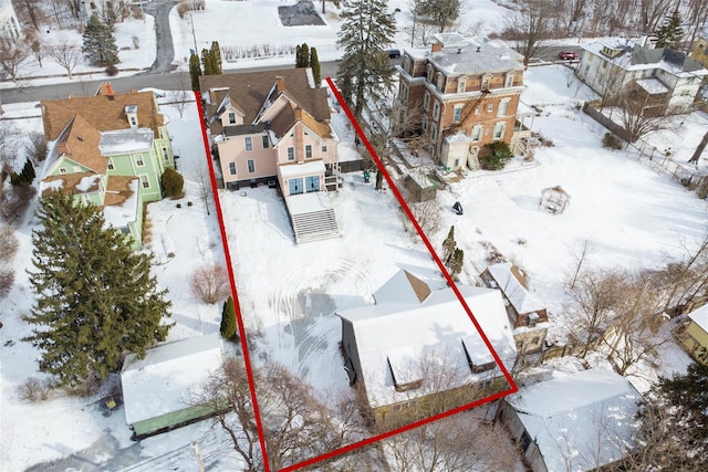 snowy aerial view featuring a residential view