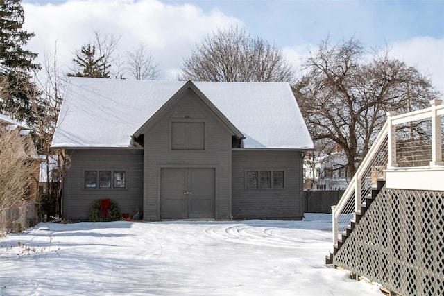exterior space featuring a garage and stairs