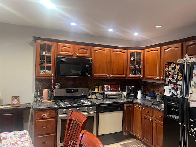 kitchen with black appliances, glass insert cabinets, decorative backsplash, and recessed lighting