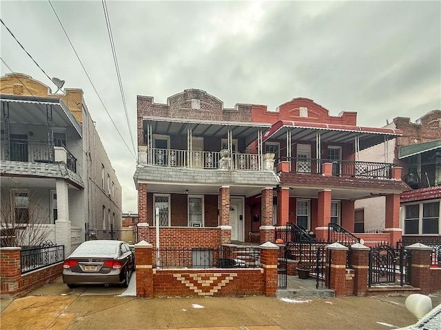 multi unit property featuring brick siding and fence