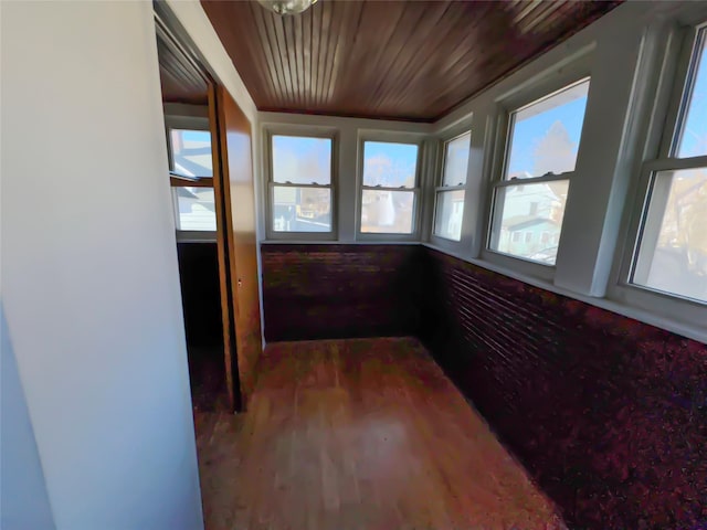 unfurnished sunroom featuring wooden ceiling