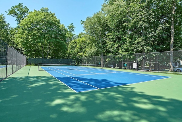 view of tennis court with fence