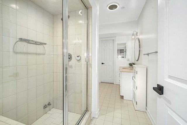 full bath with tile patterned flooring, a shower stall, vanity, and baseboards