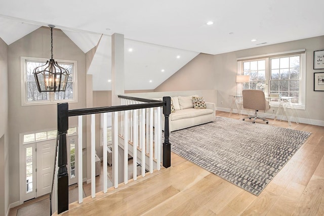 living room featuring a notable chandelier, recessed lighting, vaulted ceiling, wood finished floors, and baseboards