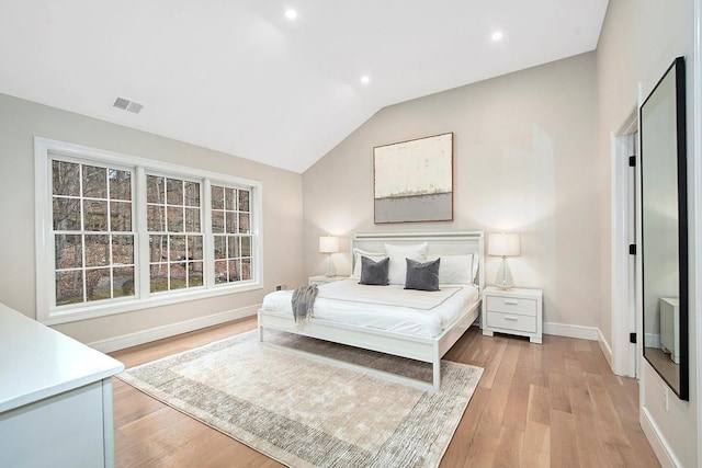 bedroom featuring recessed lighting, visible vents, light wood-style floors, vaulted ceiling, and baseboards