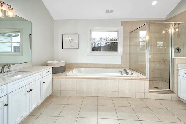 bathroom with visible vents, vaulted ceiling, vanity, a shower stall, and a bath