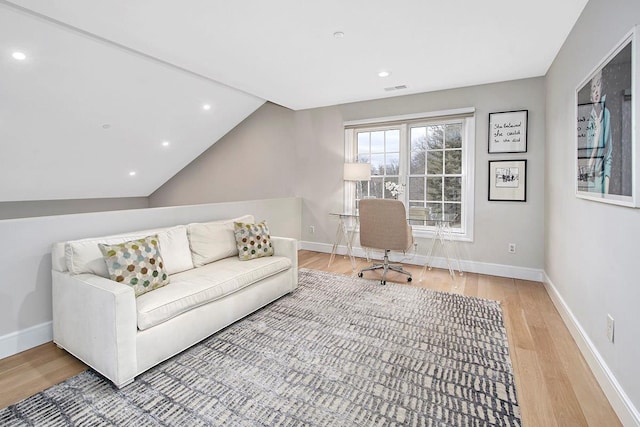 office area with lofted ceiling, wood finished floors, visible vents, and baseboards