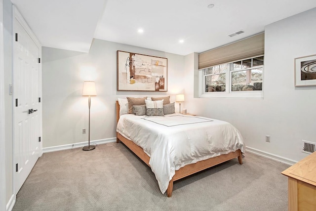 bedroom featuring light carpet, visible vents, and baseboards