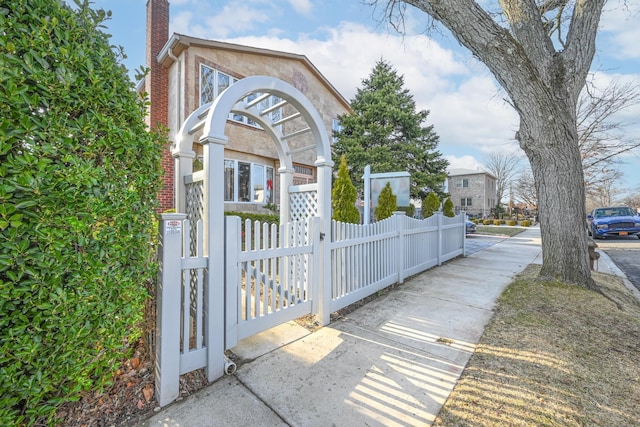 exterior space featuring a chimney and fence