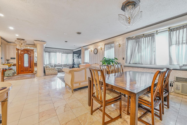 dining space with a textured ceiling, recessed lighting, and a healthy amount of sunlight