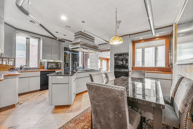 kitchen featuring a textured ceiling, white cabinets, black appliances, modern cabinets, and pendant lighting