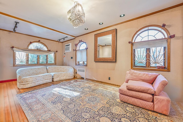 living room with ornamental molding, plenty of natural light, and radiator heating unit