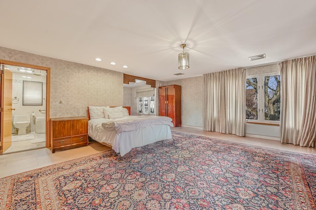 bedroom featuring light tile patterned flooring, recessed lighting, visible vents, ensuite bath, and wallpapered walls