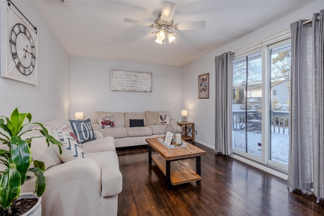 living area with ceiling fan, dark wood finished floors, and baseboards