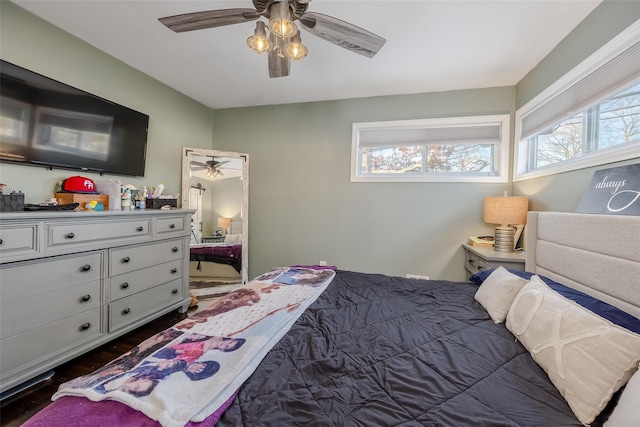 bedroom with dark wood-style floors and a ceiling fan