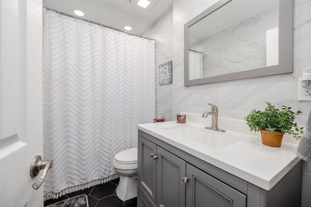 bathroom featuring curtained shower, toilet, recessed lighting, vanity, and tile walls