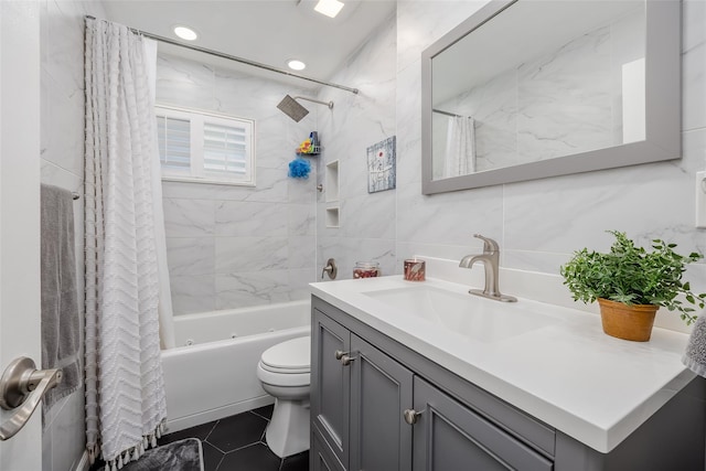 full bath with toilet, vanity, tile walls, backsplash, and shower / bath combo with shower curtain