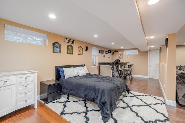 bedroom with light wood-style floors, recessed lighting, and baseboards