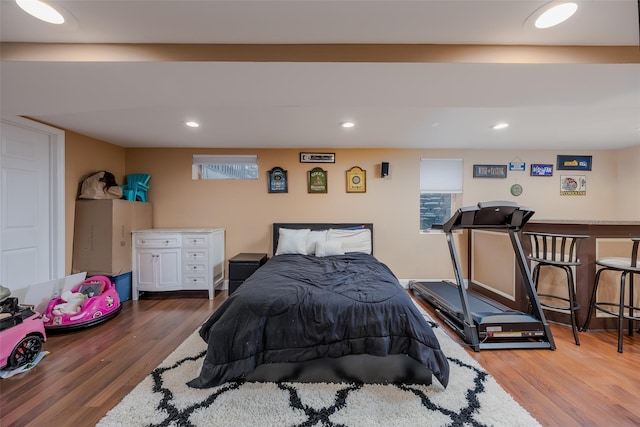 bedroom with wood finished floors and recessed lighting