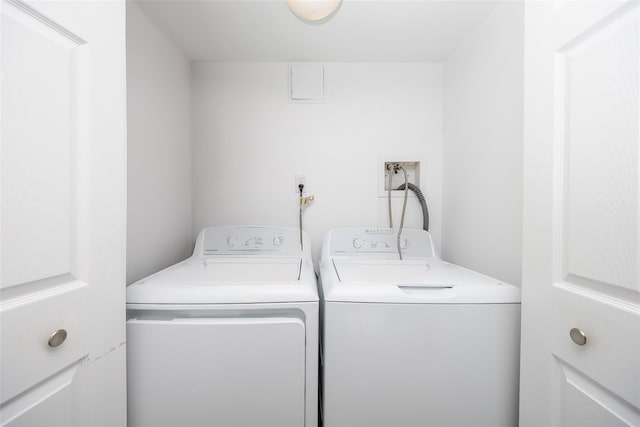 clothes washing area featuring laundry area and washer and clothes dryer