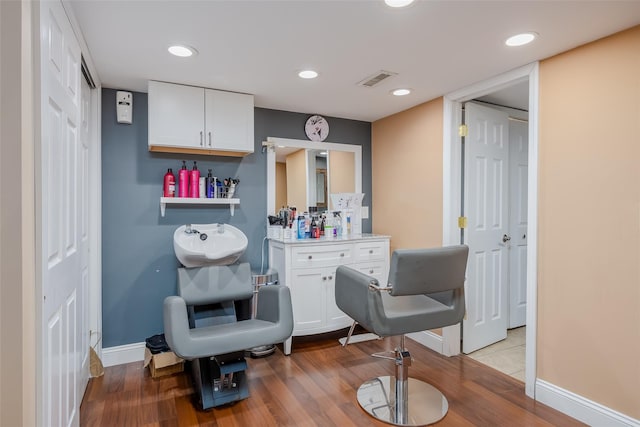 interior space featuring baseboards, light wood-type flooring, visible vents, and recessed lighting