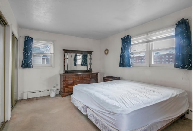 bedroom featuring carpet flooring and baseboard heating