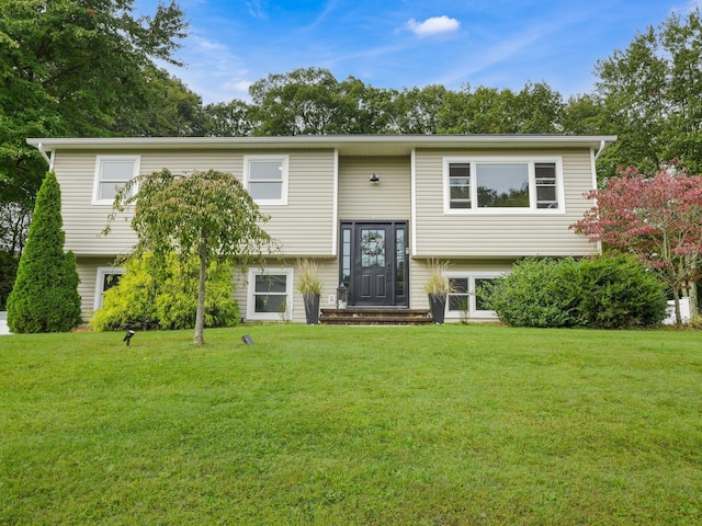 raised ranch featuring a front lawn