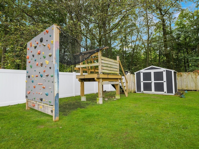 view of yard featuring an outbuilding, a storage unit, and a fenced backyard