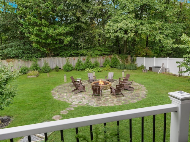 view of yard with a fenced backyard, a patio, and a fire pit