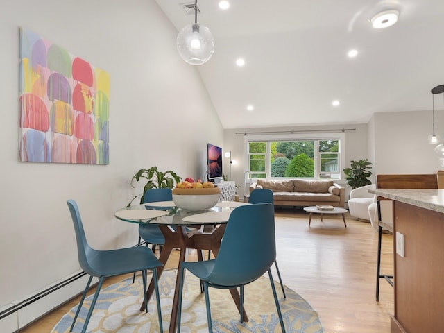 dining space featuring a baseboard radiator, visible vents, light wood finished floors, and recessed lighting