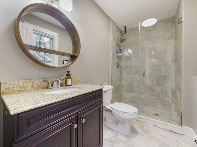 full bath with vanity, a shower stall, and toilet