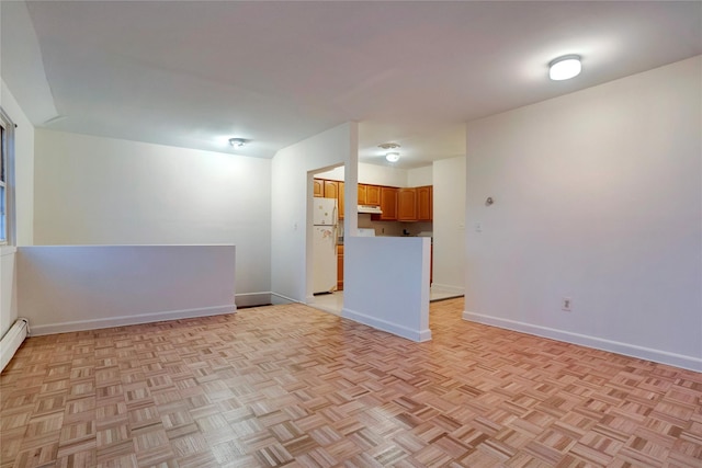 spare room featuring baseboards