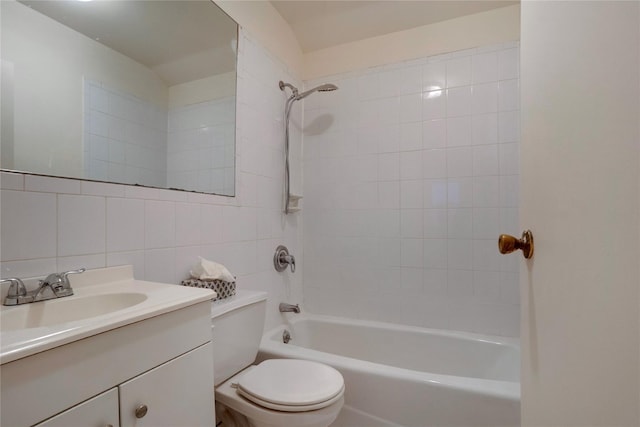 full bath with tasteful backsplash, toilet, bathtub / shower combination, vanity, and tile walls