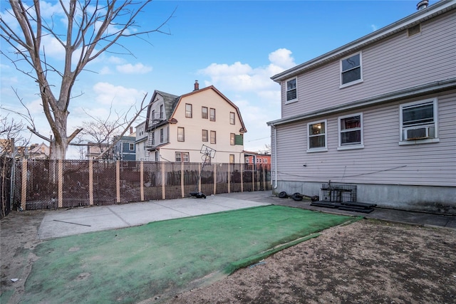 exterior space featuring a fenced backyard, cooling unit, a patio, and a yard