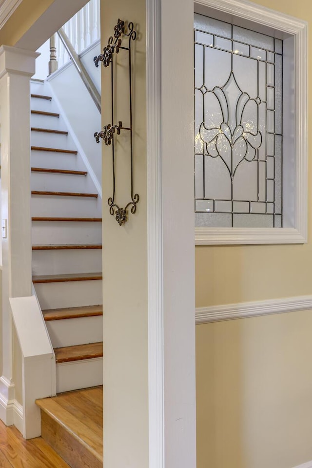 stairs featuring wood finished floors