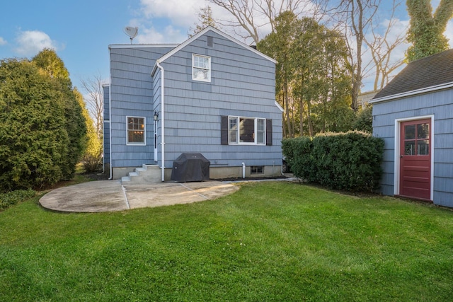 back of house featuring a patio area, entry steps, and a yard