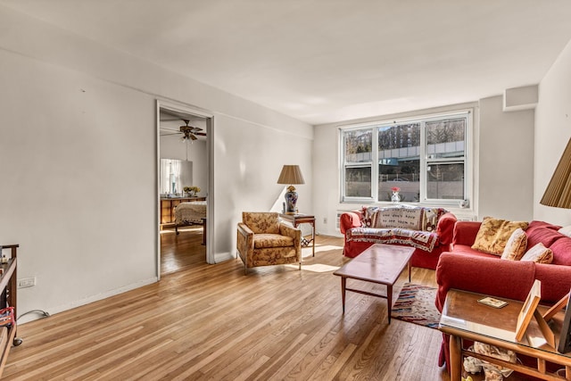 living room with baseboards and wood finished floors